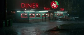 Movie still from “Horns” (2013), directed by Alexandre Aja – A diner with neon lights on the outside of the building; Wide shot, High angle