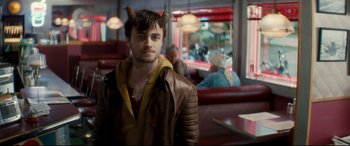 Movie still from “Horns” (2013), directed by Alexandre Aja – A man in a leather jacket with horns on his head; Medium shot, Over the shoulder angle