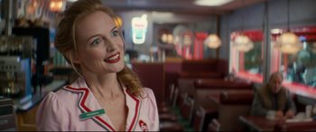 Movie still from “Horns” (2013), directed by Alexandre Aja – A woman in a pink and white shirt in a restaurant; Close Up shot, Over the shoulder angle