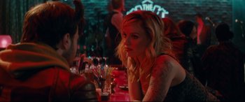 Movie still from “Horns” (2013), directed by Alexandre Aja – A woman sitting at a table with a lot of drinks; Close Up shot, Over the shoulder angle