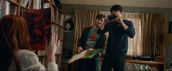 Movie still from “Horns” (2013), directed by Alexandre Aja – A man taking a picture of another man in a room; Medium shot, Over the shoulder angle
