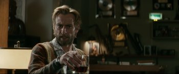 Movie still from “Horns” (2013), directed by Alexandre Aja – A man holding a glass of wine in his hand; Close Up shot, Over the shoulder angle