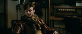Movie still from “Horns” (2013), directed by Alexandre Aja – A person with a snake around his neck; Medium shot, High angle