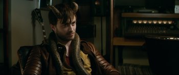 Movie still from “Horns” (2013), directed by Alexandre Aja – A man with a snake around his neck; Close Up shot, High angle