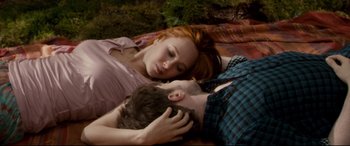 Movie still from “Horns” (2013), directed by Alexandre Aja – A man and a woman laying on the ground; Medium shot, High angle