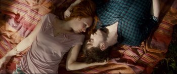 Movie still from “Horns” (2013), directed by Alexandre Aja – A man and a woman laying on a bed; Medium shot, Overhead angle