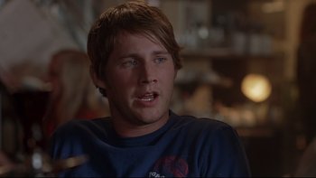 Movie still from “Hostel” (2005), directed by Eli Roth – A young man sitting in front of a mirror; Close Up shot, Over the shoulder angle