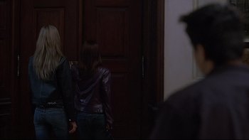 Movie still from “Hostel” (2005), directed by Eli Roth – Two women are walking in a dark hallway; Medium shot, Over the shoulder angle