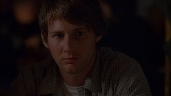 Movie still from “Hostel” (2005), directed by Eli Roth – A person sitting in front of a window; Close Up shot, Over the shoulder angle