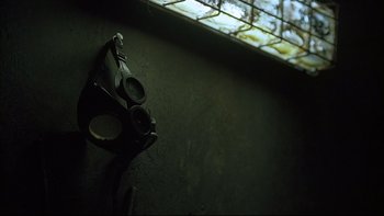 Movie still from “Hostel” (2005), directed by Eli Roth – A gun that is on the ground in a room; Extreme Close Up shot, Low angle