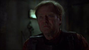 Movie still from “Hostel” (2005), directed by Eli Roth – A person wearing a uniform; Close Up shot, Low angle