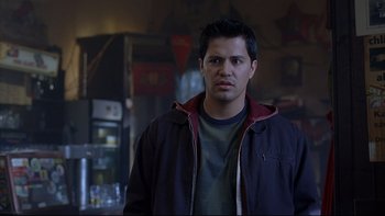 Movie still from “Hostel” (2005), directed by Eli Roth – A man standing in front of a wall; Medium shot, Over the shoulder angle