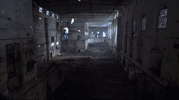 Movie still from “Hostel” (2005), directed by Eli Roth – An abandoned building with a lot of debris on the ground; Extreme Wide shot, High angle
