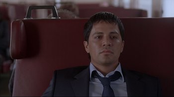 Movie still from “Hostel” (2005), directed by Eli Roth – A person wearing a suit and tie; Close Up shot, Low angle