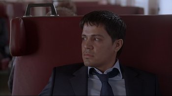 Movie still from “Hostel” (2005), directed by Eli Roth – A person wearing a suit and tie; Close Up shot, High angle