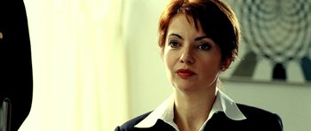 Movie still from “Hostel: Part II” (2007), directed by Eli Roth – A person wearing a suit; Close Up shot, Over the shoulder angle