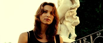 Movie still from “Hostel: Part II” (2007), directed by Eli Roth – A beautiful woman with long brown hair wearing a black shirt; Close Up shot, Low angle