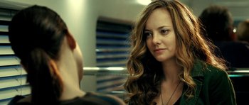 Movie still from “Hostel: Part II” (2007), directed by Eli Roth – A beautiful young woman with long brown hair; Close Up shot, Over the shoulder angle