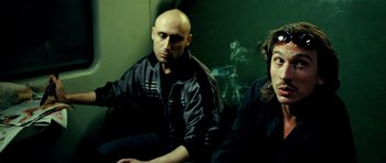 Movie still from “Hostel: Part II” (2007), directed by Eli Roth – A man and a woman sitting next to each other; Close Up shot, Low angle