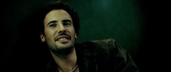 Movie still from “Hostel: Part II” (2007), directed by Eli Roth – A person sitting on a couch; Close Up shot, Low angle