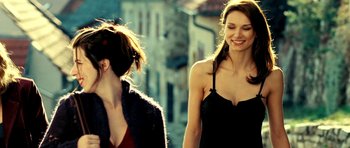Movie still from “Hostel: Part II” (2007), directed by Eli Roth – Two women walking down a street talking to each other; Close Up shot, Low angle
