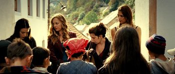 Movie still from “Hostel: Part II” (2007), directed by Eli Roth – A group of women standing next to each other on a bridge; Medium shot, Over the shoulder angle