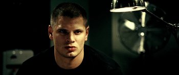 Movie still from “Hostel: Part II” (2007), directed by Eli Roth – A person wearing a black t - shirt; Close Up shot, Low angle
