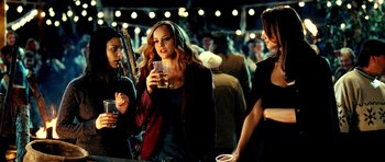 Movie still from “Hostel: Part II” (2007), directed by Eli Roth – A group of people standing around a crowd of people; Medium shot, Over the shoulder angle