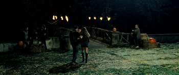 Movie still from “Hostel: Part II” (2007), directed by Eli Roth – A man and a woman standing next to each other in the dark; Wide shot, High angle