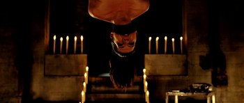 Movie still from “Hostel: Part II” (2007), directed by Eli Roth – A man hanging upside down in the dark; Medium shot, Overhead angle