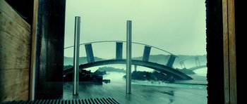 Movie still from “Hostel: Part II” (2007), directed by Eli Roth – A view of a bridge that is going over a body of water; Extreme Wide shot, High angle