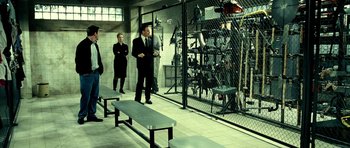 Movie still from “Hostel: Part II” (2007), directed by Eli Roth – A group of people standing next to each other in a room; Wide shot, High angle