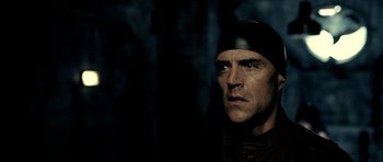 Movie still from “Hostel: Part II” (2007), directed by Eli Roth – A person wearing a hat; Close Up shot, Low angle