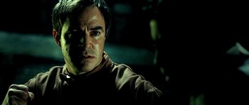 Movie still from “Hostel: Part II” (2007), directed by Eli Roth – A person wearing a brown shirt; Close Up shot, Over the shoulder angle