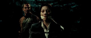 Movie still from “Hostel: Part II” (2007), directed by Eli Roth – A woman tied up with a bandage on her face; Close Up shot, Over the shoulder angle