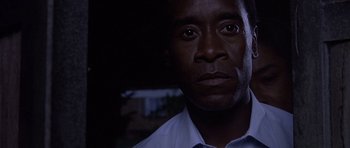 Movie still from “Hotel Rwanda” (2004), directed by Terry George – A person wearing a white shirt; Close Up shot, Low angle