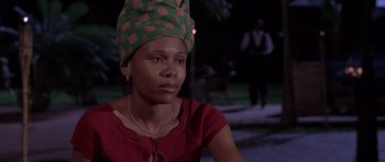 Movie still from “Hotel Rwanda” (2004), directed by Terry George – A woman wearing a green and red head covering; Close Up shot, Low angle