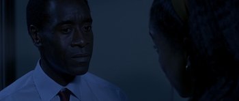 Movie still from “Hotel Rwanda” (2004), directed by Terry George – A man and a woman are looking at each other in the dark; Close Up shot, Over the shoulder angle