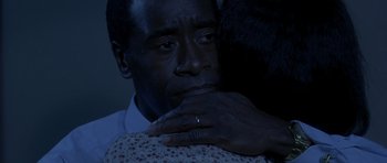 Movie still from “Hotel Rwanda” (2004), directed by Terry George – A man and a woman hugging in a dark room; Close Up shot, Over the shoulder angle