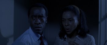 Movie still from “Hotel Rwanda” (2004), directed by Terry George – A man and a woman standing next to each other in the dark; Close Up shot, Low angle