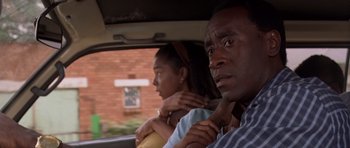 Movie still from “Hotel Rwanda” (2004), directed by Terry George – A man and a woman sitting in the back of a car; Close Up shot, Over the shoulder angle