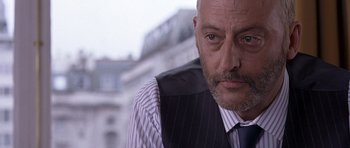 Movie still from “Hotel Rwanda” (2004), directed by Terry George – A person wearing a suit and tie; Close Up shot, Low angle