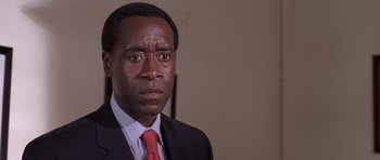 Movie still from “Hotel Rwanda” (2004), directed by Terry George – A person wearing a suit and tie; Close Up shot, Low angle