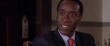 Movie still from “Hotel Rwanda” (2004), directed by Terry George – A person wearing a suit and tie; Close Up shot, Low angle