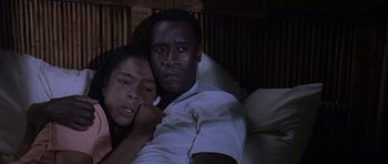 Movie still from “Hotel Rwanda” (2004), directed by Terry George – A man and a woman sitting on a bed; Close Up shot, High angle