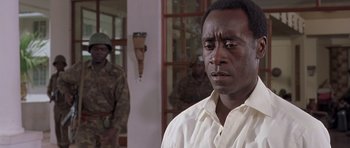 Movie still from “Hotel Rwanda” (2004), directed by Terry George – A man standing in front of a group of soldiers; Close Up shot, Over the shoulder angle
