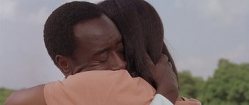 Movie still from “Hotel Rwanda” (2004), directed by Terry George – A man and a woman hugging each other; Close Up shot, High angle