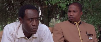 Movie still from “Hotel Rwanda” (2004), directed by Terry George – Two men sitting next to each other on a park bench; Close Up shot, Over the shoulder angle