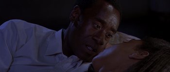 Movie still from “Hotel Rwanda” (2004), directed by Terry George – A person sitting in front of a window; Close Up shot, Over the shoulder angle