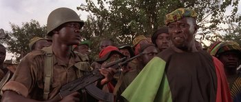 Movie still from “Hotel Rwanda” (2004), directed by Terry George – A group of men standing next to each other holding guns; Close Up shot, Low angle
